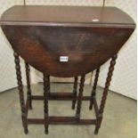 A small 1920s oak oval drop leaf gateleg occasional table, raised on eight slender turned bobbin