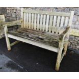 A weathered teak two seat garden bench with slatted seat and back 120 cm long (af)