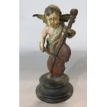 A 19th century cold painted Cherub playing a cello, raised on a circular base. 11cm tall.
