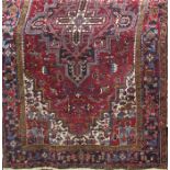 A large Persian carpet with a central stepped medallion with stylised flowers, 350cm x 277cm