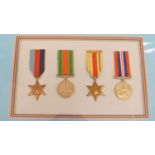 A cased set of four WWII medals, 39, 45 and Africa Star, Defence Medal, 39, 45 war medal, framed,