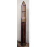 A mock artillery shell made from original military shell metal with a wooden case