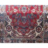 A large Persian design carpet with floral decoration to the central medallion, 315cm x 215cm