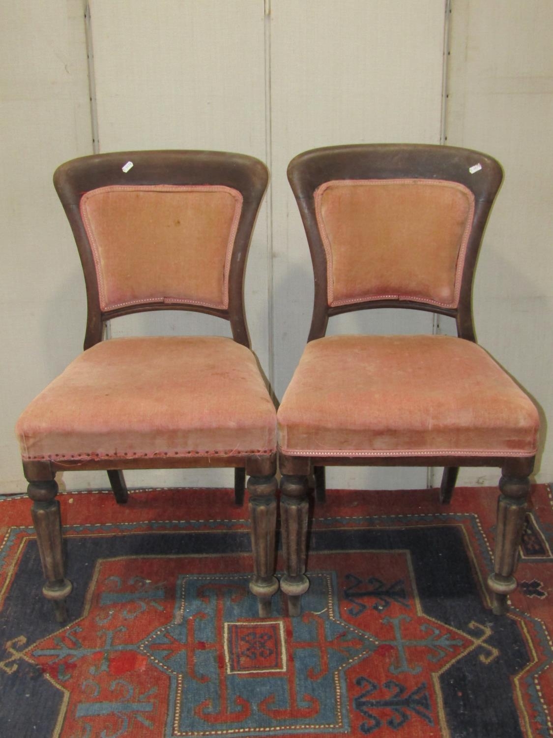 A set of four Victorian mahogany dining chairs with upholstered seats and back pads within a