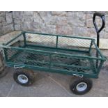 A small useful hand cart with green painted metal lattice panelled body with drop sides and