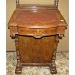 A Victorian walnut and figured walnut veneered davenport with inlaid detail and fitted with the