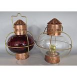 Two identically made Full Inch copper and brass spherical oil lamps, one with a red shade, the other