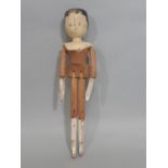 A 19th-century Dutch type wooden Peg doll, painted head and features, jointed limbs, height 29cm.