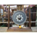 Tibetan gong with painted detail, raised upon hardwood stand, complete with strike, 95cm wide
