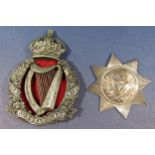 Royal Irish Constabulary helmet badge and a William IV silver badge, star shaped outline with