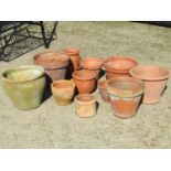 Small quantity of terracotta outsized flower pots and planters of varying size and design (some af)
