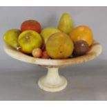 A collection of composite fruit, bananas, apples, oranges, cherries etc in an alabaster bowl.