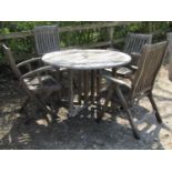 A weathered Canterbury Collection teak circular drop-leaf garden table, 124cm diameter, together