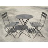 A contemporary three piece light steel folding bistro set comprising circular topped table, 60cm