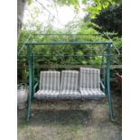Three seat garden swing with green painted tubular steel and swept frame, beneath an adjustable