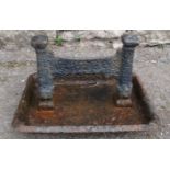 A 19th century cast iron boot scraper with rectangular tray base