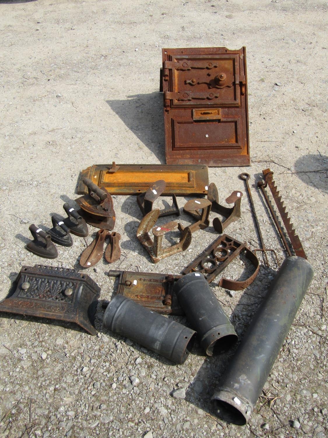 The remains of an antique cast iron range, further fire related items, cast iron flat irons, various