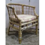 A sturdy bamboo framed tub chair with loose cushion