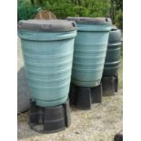 Three moulded plastic water butts and stands