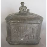 A 19th century lead tobacco jar with seated Middle Eastern man smoking to the lid and humorous scene