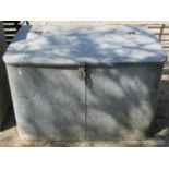 A vintage heavy gauge galvanised steel grain bin with hinged sloping lid and rounded front