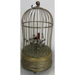 A 19th century singing bird automaton within a brass cage, 28cm high. (in working order)