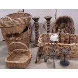 A collection of turned timber candlesticks, further brass table lamps, wicker baskets, etc