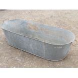 A vintage two handled galvanised tin bath of oval tapered form, 137 cm long x 50 cm wide (at
