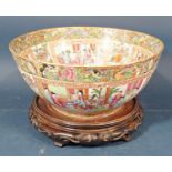 A large 19th century Famille Rose bowl with typical landscape, character and other panels within a