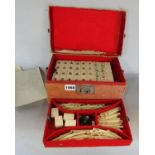 A cased Mah-jong set with bone and bamboo pieces. (Complete, box af)