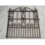 A heavy gauge iron pedestrian gate with scroll work detail and sprung lever latch, 112 cm wide x 110