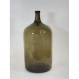 A large green glass Demi John type bottle, 62cm high