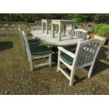 A good quality heavy gauge weathered/silvered teak D end extending garden table with central bi-