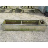 A heavy gauge galvanised steel field water trough of rectangular form with rounded rim 185 cm long x