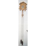 A small traditional Tyrolean carved softwood cuckoo clock, with pine cone shaped weights