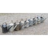 Nine vintage galvanised steel watering cans of varying design and capacity (lacks roses)