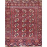 An early 20th century Tekke rug with three rows of gul on a faded purple ground. 150cm x 110cm