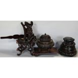 A collection of Chinese hardwood vase stands and plate stands including a bat carved example and two
