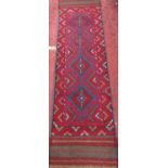 A Meshwani runner with an interlocking red and blue diamond pattern.236cm x 60cm.