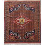 A Kazak style carpet with a central stepped lozenge with stylised birds to borders. 170cm x 103cm