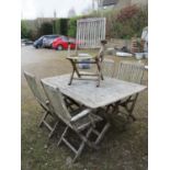 A Hartman weathered teak folding x framed garden table of rectangular form with slatted panelled top