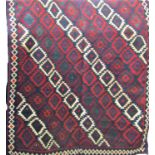 A large Shiraz kelim carpet with a multi coloured geometric pattern. 320cm x 170cm approx