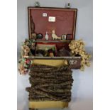 A small vintage suitcase 40cm wide, containing several metres of tassels and braiding and a pearly