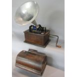 An Edison Standard Phonograph in original oak case, with winder and seven wax records. (In