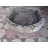 A weathered natural stone D shaped trough with square central drain, 53cm wide x 53cm deep x 19cm