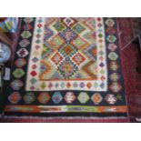 A Choi kilim with a brightly coloured central geometric panel. 157cm x 105cm.