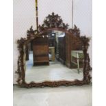 Decorative gilded overmantle mirror with shaped and pierced floral borders, 150 x 115cm approx