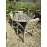 Weathered teak garden table, the rectangular slatted top with curved ends raised on square cut and