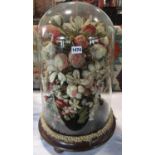 Victorian wool work flowers under a glass dome on a mahogany stand. 58cm high.