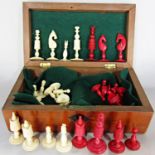 A 19th century red and white bone chess set contained in a wooden box.(Complete)